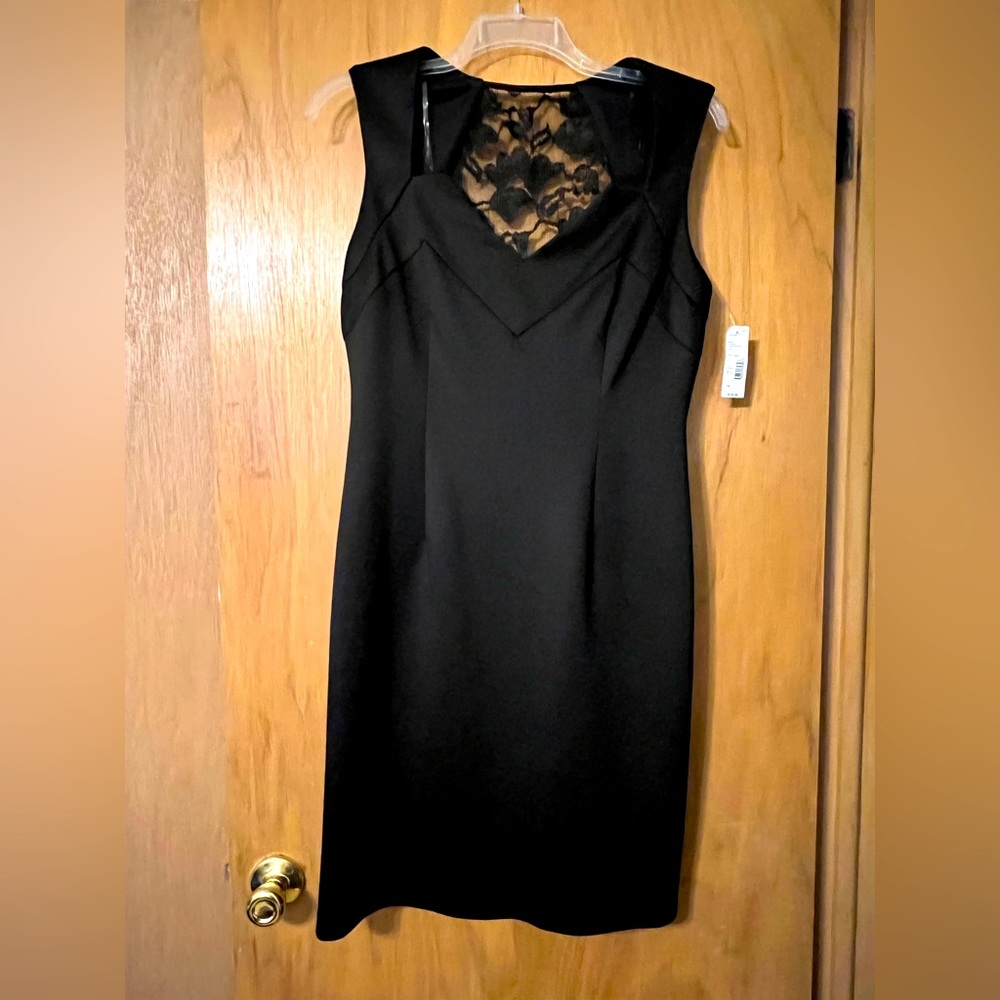 Sleeveless fitted black dress with lace detail on the back